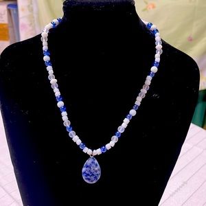 Handmade necklace with blue stone pendant.